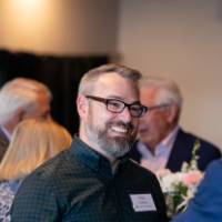 Nick Carlson smiling at other reception attendee